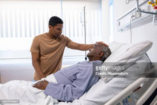 loving son visiting his father at the hospital - family hospital old stock pictures, royalty-free photos & images