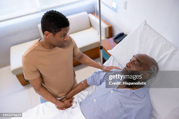 man visiting his father at the hospital - family hospital old stock pictures, royalty-free photos & images