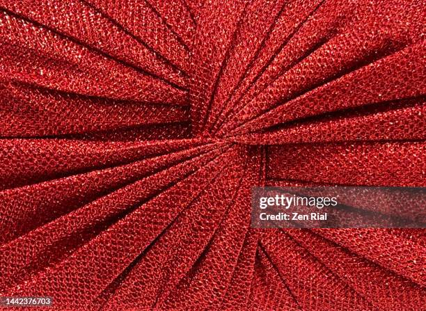 detail on a red purse with fanned out pattern in full frame - abrir en abanico fotografías e imágenes de stock