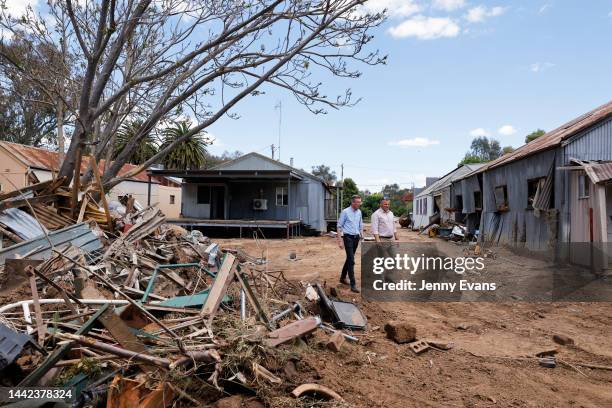 Premier Dominic Perrottet and State Member for Orange Philip Donato walk through flood damaged businesses on November 18, 2022 in Eugowra, Australia....