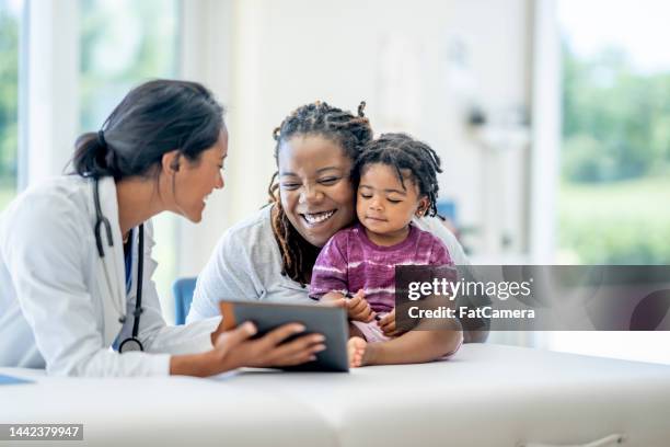 cita médica familiar - doctors fotografías e imágenes de stock