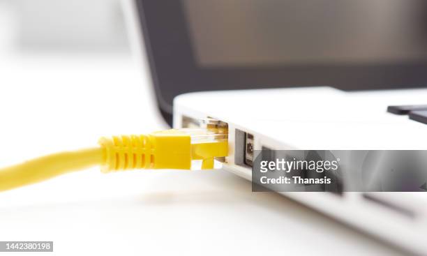 ethernet cable connected to a laptop - modem stock pictures, royalty-free photos & images