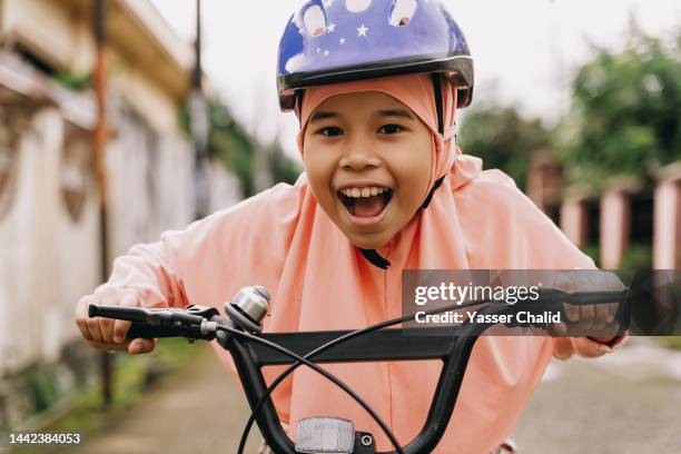 little girl ride bicycle outside - kids fun indonesia stock pictures, royalty-free photos & images