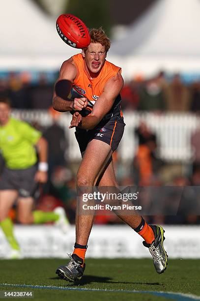 Andrew Phillips of the Giants handballs during the round seven AFL match between the Greater Western Sydney Giants and the Gold Coast Suns at Manuka...