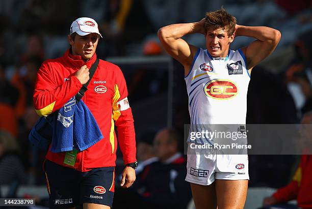 David Swallow of the Suns leaves the ground injured during the round seven AFL match between the Greater Western Sydney Giants and the Gold Coast...