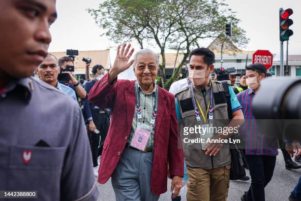 Former Malaysia Prime Minister and founder of the Gerakan Tanah Air coalition Mahathir Mohamad , waves outside the nomination center for the upcoming...