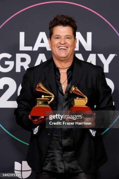 Carlos Vives poses with the awards for Best Contemporary Tropical Album and Best Pop/Rock Song in the press room for the 23rd Annual Latin GRAMMY...