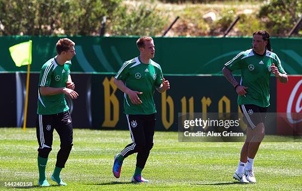 Goalkeepers Ron-Robert Zieler, Marc-Andre ter Stegen and Tim Wiese run during a Germany training session at Campo Sportivo Comunale Andrea Dora on...