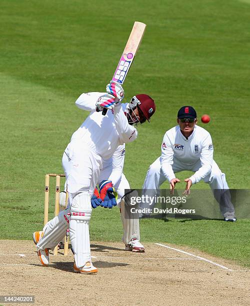 Darren Bravo of the West Indies drives the ball for four runs to bring up his half century during the England Lions v West Indies match at The County...