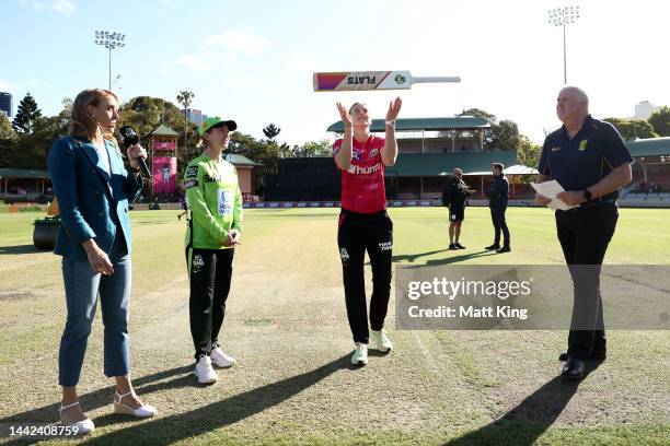 Captain's Ellyse Perry of the Sixers and Rachael Haynes of the Thunder take part in the bat flip during the Women's Big Bash League match between the...