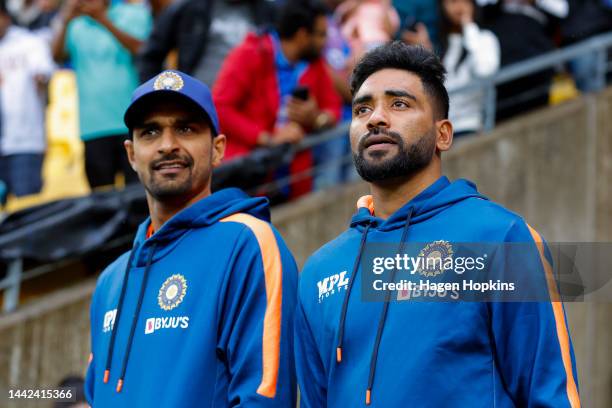 Deepak Hooda and Mohammed Siraj of India look on prior to game one of the T20 International series between New Zealand and India at Sky Stadium on...
