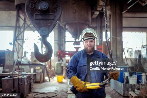 portrait of apprentice foundry worker in iron foundry - operário siderúrgico imagens e fotografias de stock