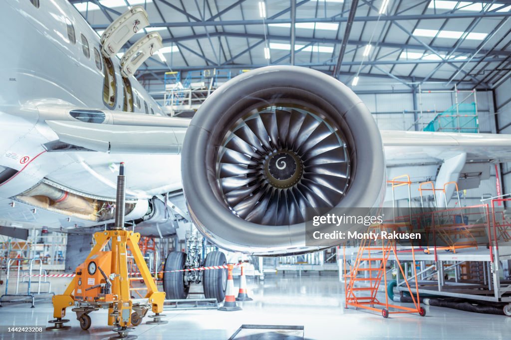Large jet engine in aircraft maintenance hangar