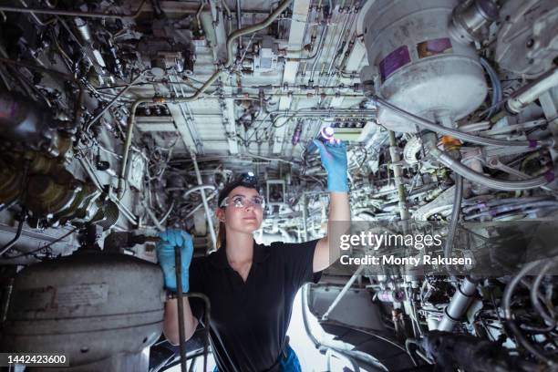 female apprentice aircraft maintenance engineer inspecting wheel well on jet - airplane wheel well stock pictures, royalty-free photos & images