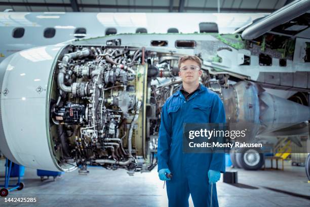 portrait of apprentice aircraft maintenance engineer with jet engine - monty rakusen portrait stock pictures, royalty-free photos & images