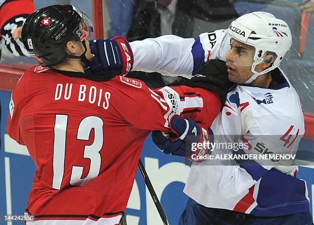 French Pierre-Edouard Bellemare fights with Swiss Felicien du Bois on May 12, 2012 during a preliminary round game of the International Ice Hockey...