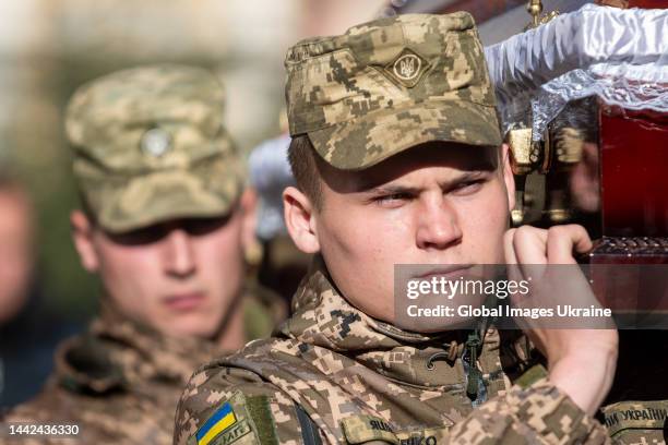 Soldiers of an honor guard carry the coffin of a fallen soldier on November 10, 2022 in Lviv, Ukraine. On November 1, Plast member Taras-Tymofii...