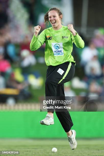 Sam Bates of the Thunder celebrates taking the wicket of Alyssa Healy of the Sixers during the Women's Big Bash League match between the Sydney...