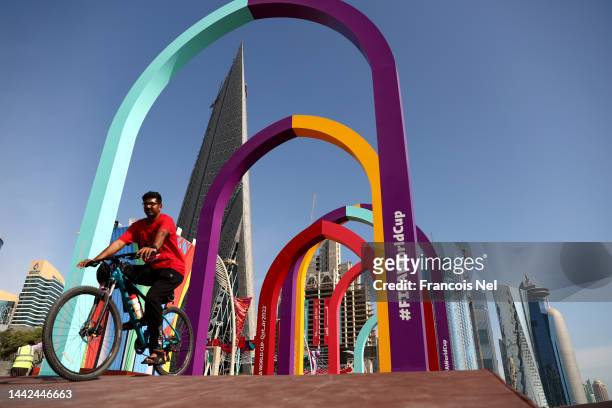 Man rides a bicycle at Doha Corniche ahead of the FIFA World Cup Qatar 2022 at on November 18, 2022 in Doha, Qatar.
