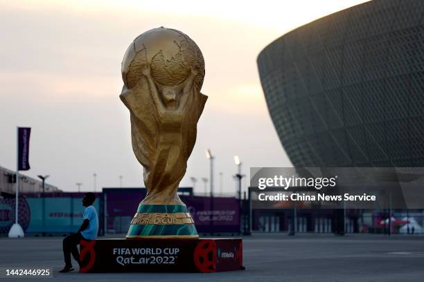 Sculpture of the FIFA World Cup trophy stands outside Lusail Stadium, which will host the final during the FIFA World Cup Qatar 2022, on November 17,...