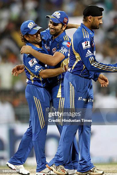 Mumbai Indians players Sachin Tendulkar with Captain Harbhajan Singh celebrating after winning the match against Kolkata Knight Riders at Eden...