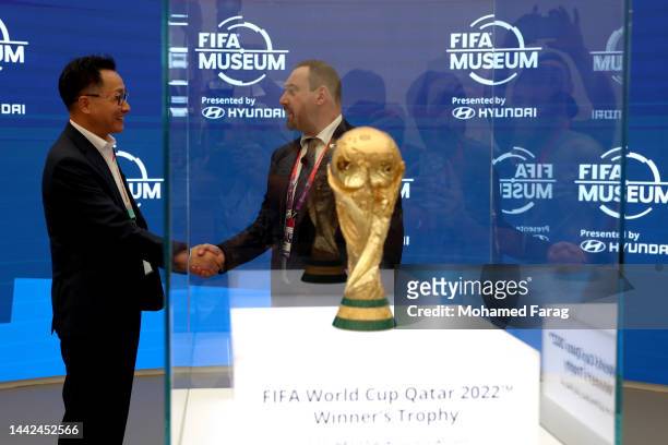 Unsoo Kim and Marco Fazonne unveil the 2022 FIFA World Cup Trophy at the FIFA Museum presented by Hyundai during the FIFA Fan Festival on November...