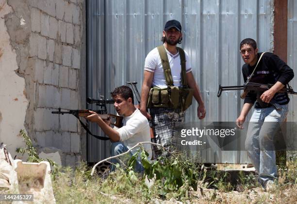 Member of the Free Syrian Army's "Freedom for the River Assi Brigade" take part on an attack on Syrian regime forces in the village of Nizareer, near...