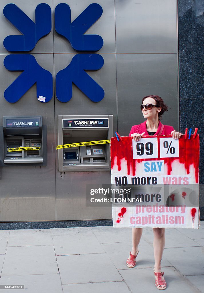 A demonstrator holds up a banner after a