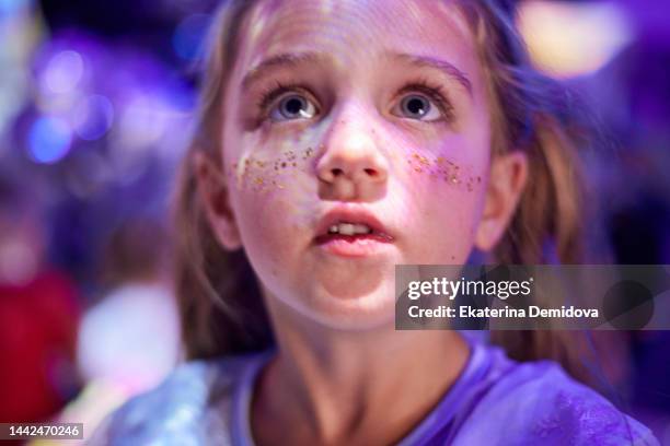 child's face close-up on a holiday in neon light - college girl pics ストックフォトと画像