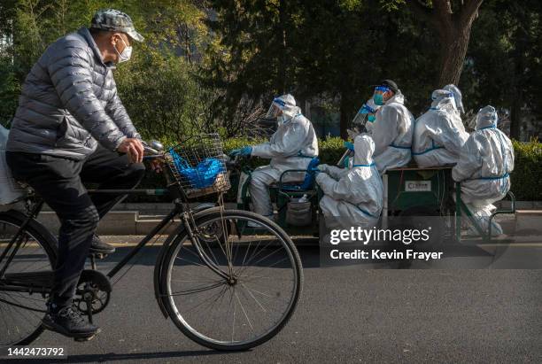 Epidemic control workers ride in a vehicle in an area where communities are in lockdown or health monitoring to prevent the spread of COVID-19 on...
