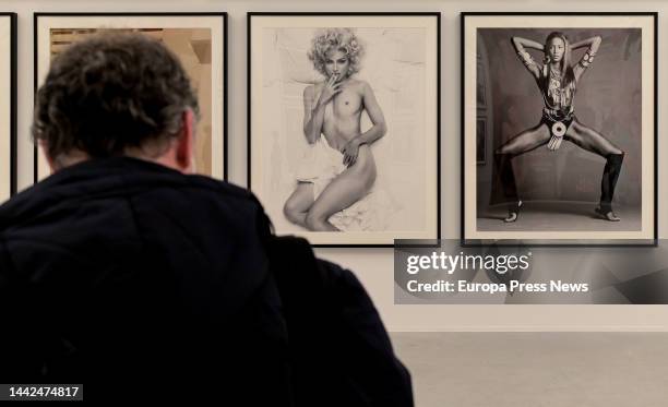 Man looks at photographs in the exhibition 'Steven Meisel 1993 A Year in Photographs' at the Muelle de la Bateria in A Coruña, on 18 November, 2022...