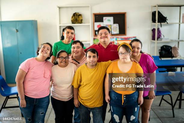 portrait of disabled students in the classroom at school - teenager cerebral palsy stock pictures, royalty-free photos & images