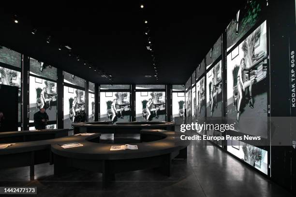 Several people look at the projections on the walls of the exhibition 'Steven Meisel 1993 A Year in Photographs' at the Muelle de la Bateria in A...