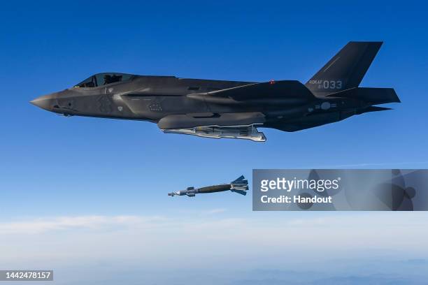 In this handout image released by the South Korean Defense Ministry, A South Korean Air Force F-35 fighter jet fires bomb into an target during the...
