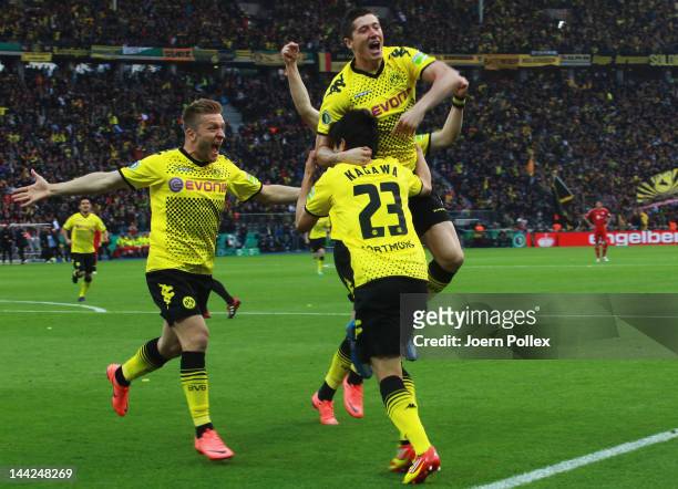 Shinji Kagawa of Dortmund celebrates with his team mates after scoring his team's first goal during the DFB Cup final match between Borussia Dortmund...