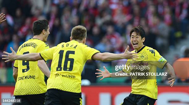 Dortmund's Japanese forward Shinji Kagawa is congratulated by Dortmund's Polish midfielder Jakub Blaszczykowski after scoring during the German cup "...