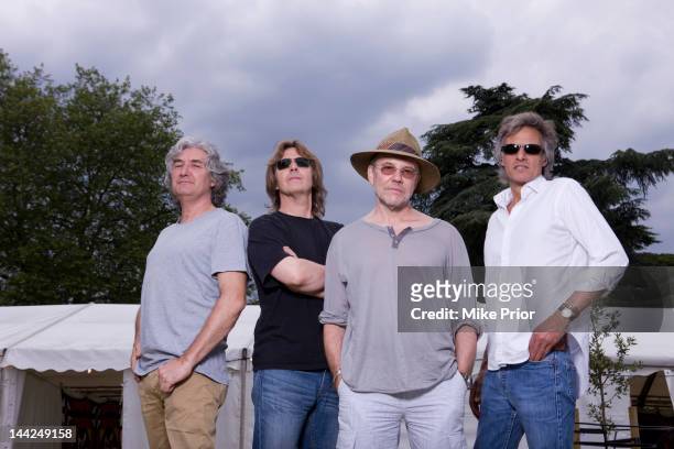3rd JULY: Phil Palmer, Terence Reis, Alan Clark and Chris White of The Straits pose backstage at the Cornbury Music Festival near Oxford, England on...