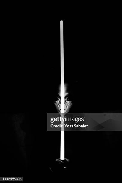 an extraterrestrial wields a laser sword - laser sword stock pictures, royalty-free photos & images