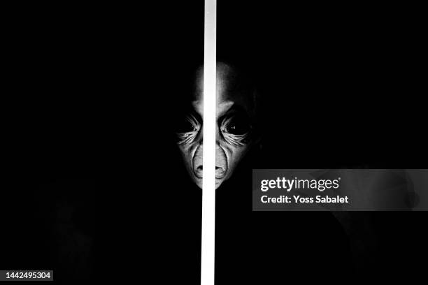 close-up portrait of an extra terrestrial with a laser sword in the center. - alien arrival stock pictures, royalty-free photos & images