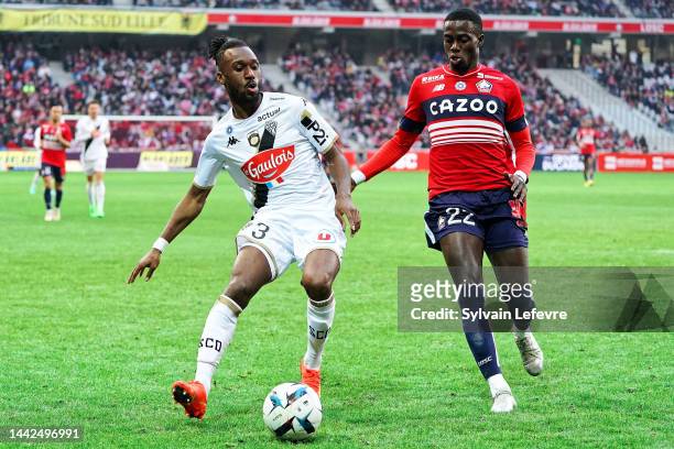 Souleyman Doumbia of Angers SCO is challenged by Timothy Weah of Lille OSC during the Ligue 1 match between Lille OSC and Angers SCO at Stade...