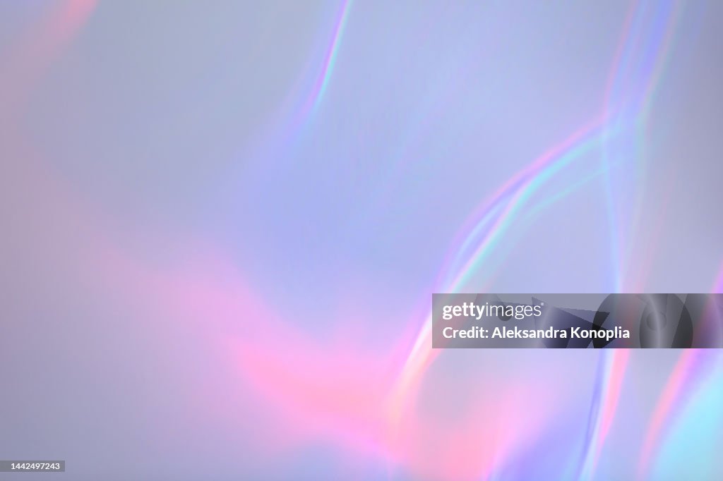 Surreal aura rainbow laser light refraction texture overlay effect on white wall