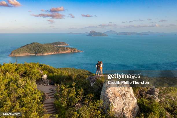 couple enjoying view from atop passage peak on hamilton island, australia - queensland people stock pictures, royalty-free photos & images