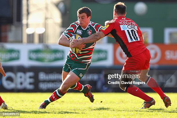 George Ford of Leicester breaks clear of Charlie Hodgson during the Aviva Premiership semi final match between Leicester Tigers and Saracens at...