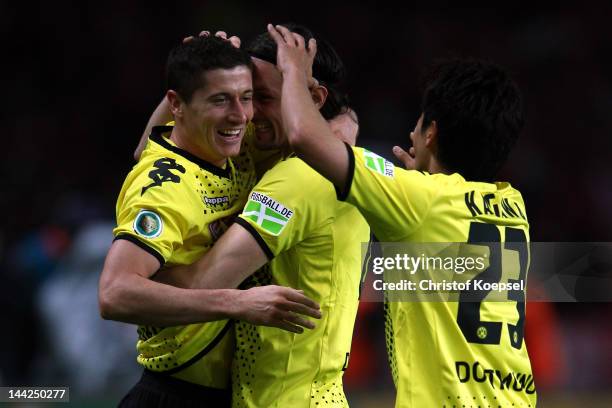 Robert Lewandowski of Dortmund celebrates the forth goal with Neven Subotic and Shinji Kagawa of Dortmund during the DFB Cup final match between...