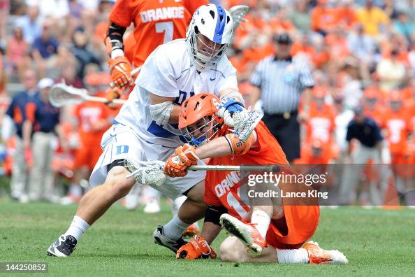 Josh Offit Ryan Barber of the Syracuse Orange falls to the ground as Josh Offit ...