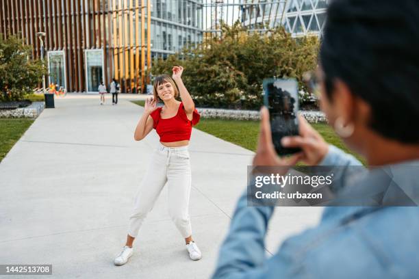 boyfriend filming his girlfriend dancing on the street in milan - dance challenge stock pictures, royalty-free photos & images