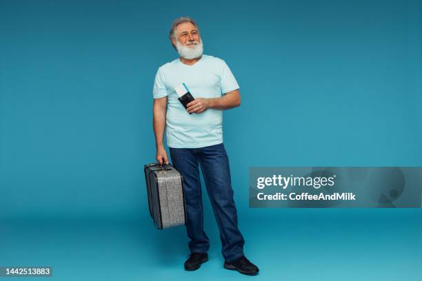 portrait of an emotional old man holding suitcase and tickets - portraits of people passport stock pictures, royalty-free photos & images