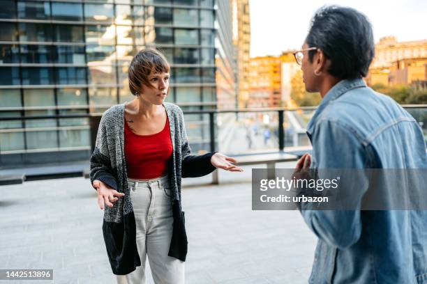 young couple arguing on the street in milan - asian couple arguing stockfoto's en -beelden