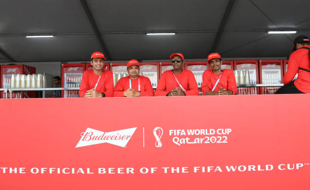 The men from the Budweiser stand pose for a photo at the Fan Festival ahead of the FIFA World Cup Qatar 2022 at Fan Festival Al Bidda Park on...