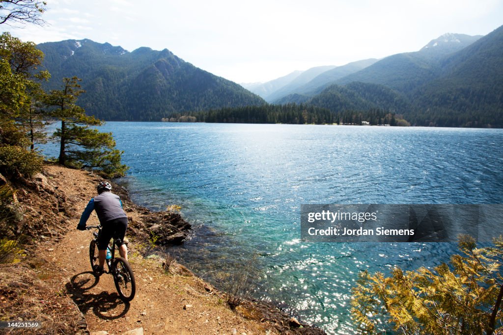 A man bike riding a scenic trail.